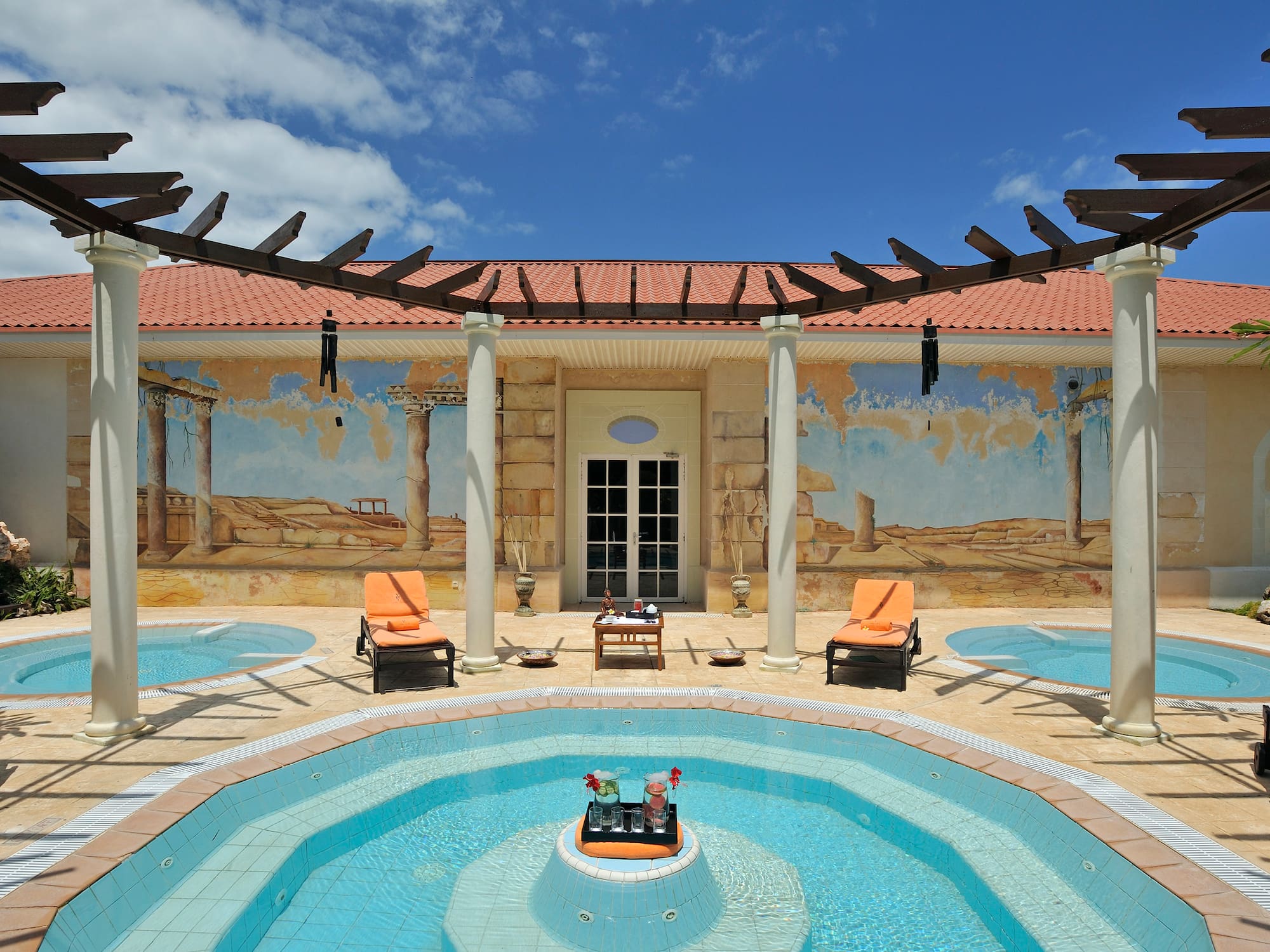 a pool with chairs and a table in the middle