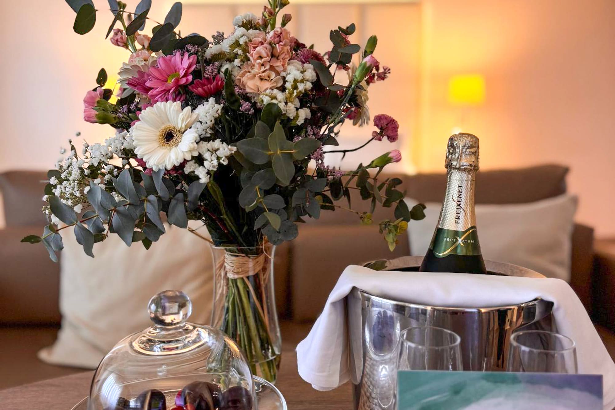Hotel welcome: fresh flowers, champagne in ice bucket, chocolates, berries.