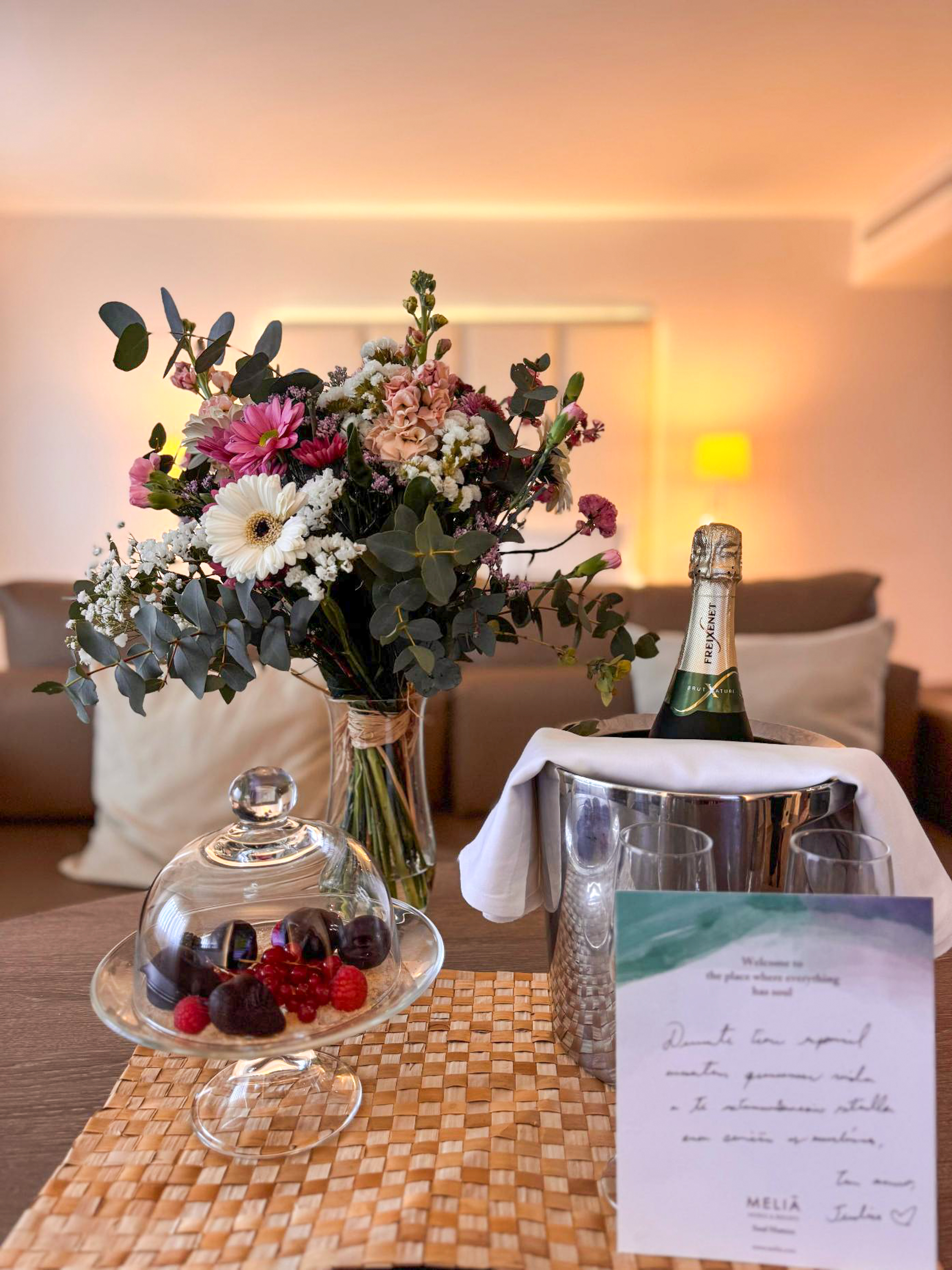 Hotel welcome: fresh flowers, champagne in ice bucket, chocolates, berries.
