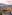 Chiang Mai Old City: temples, moat, wall, and mountains at sunrise.