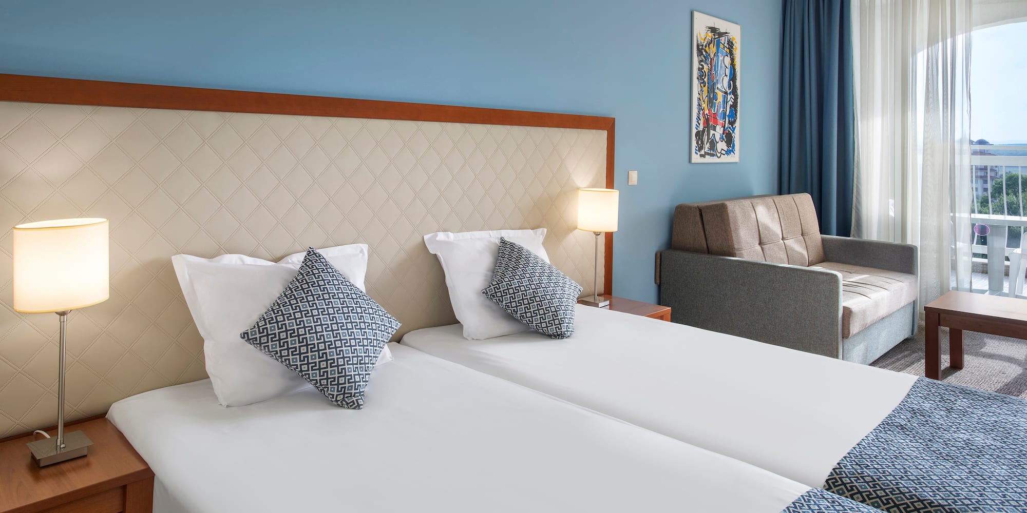 a room with two beds and a couch