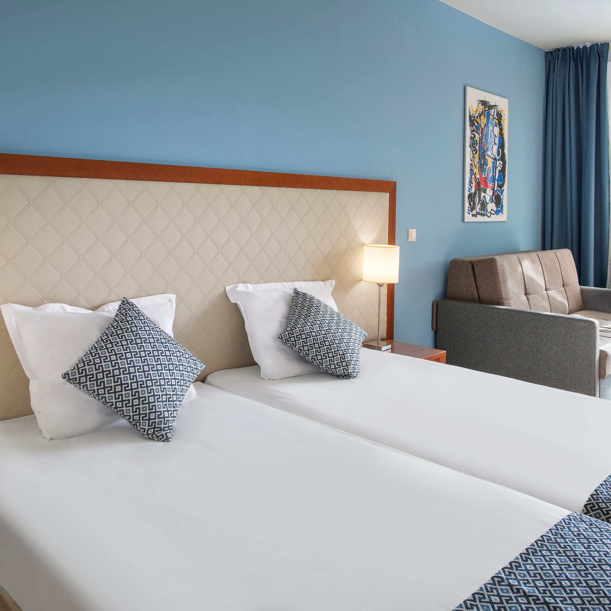 a room with two beds and a couch