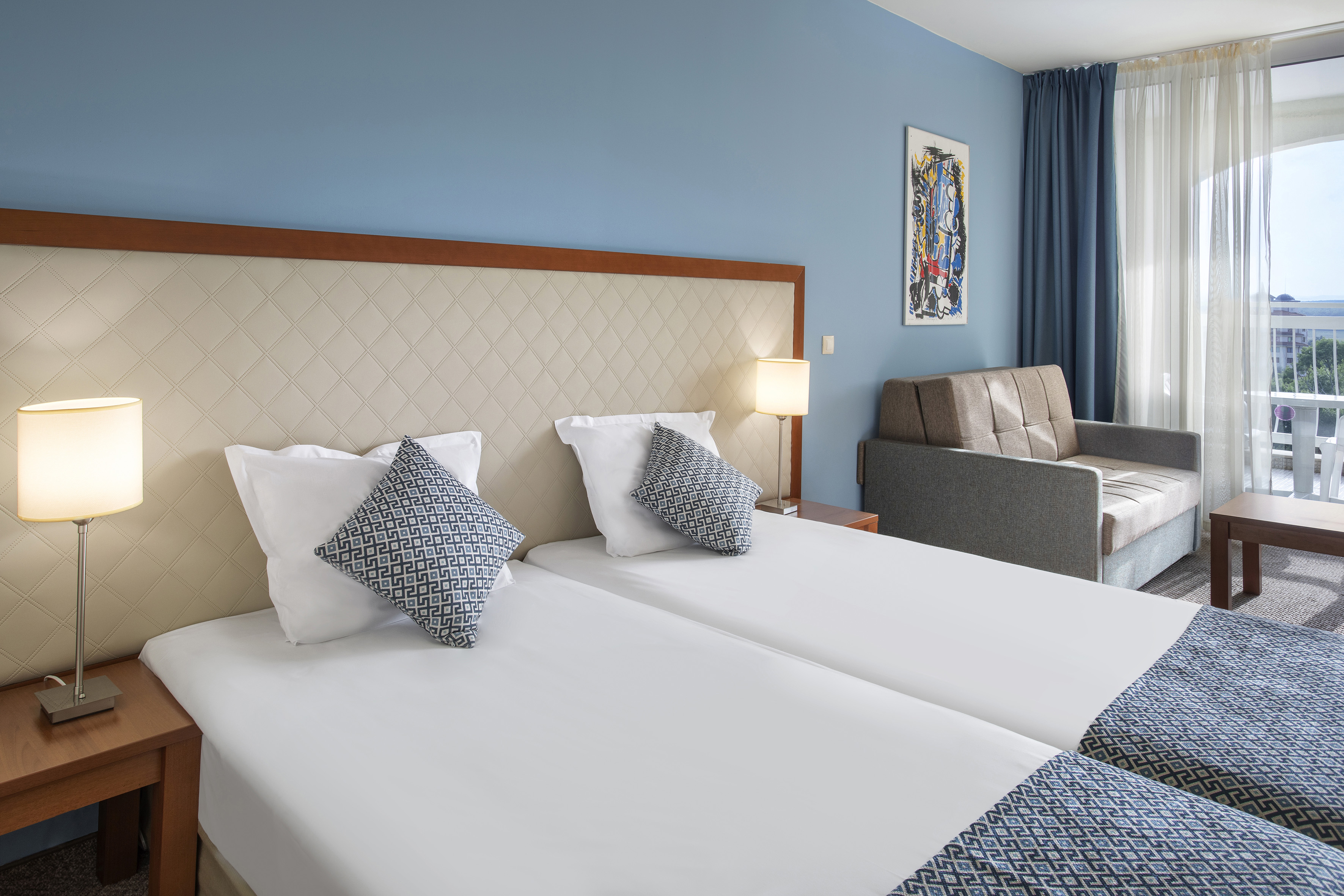 a room with two beds and a couch