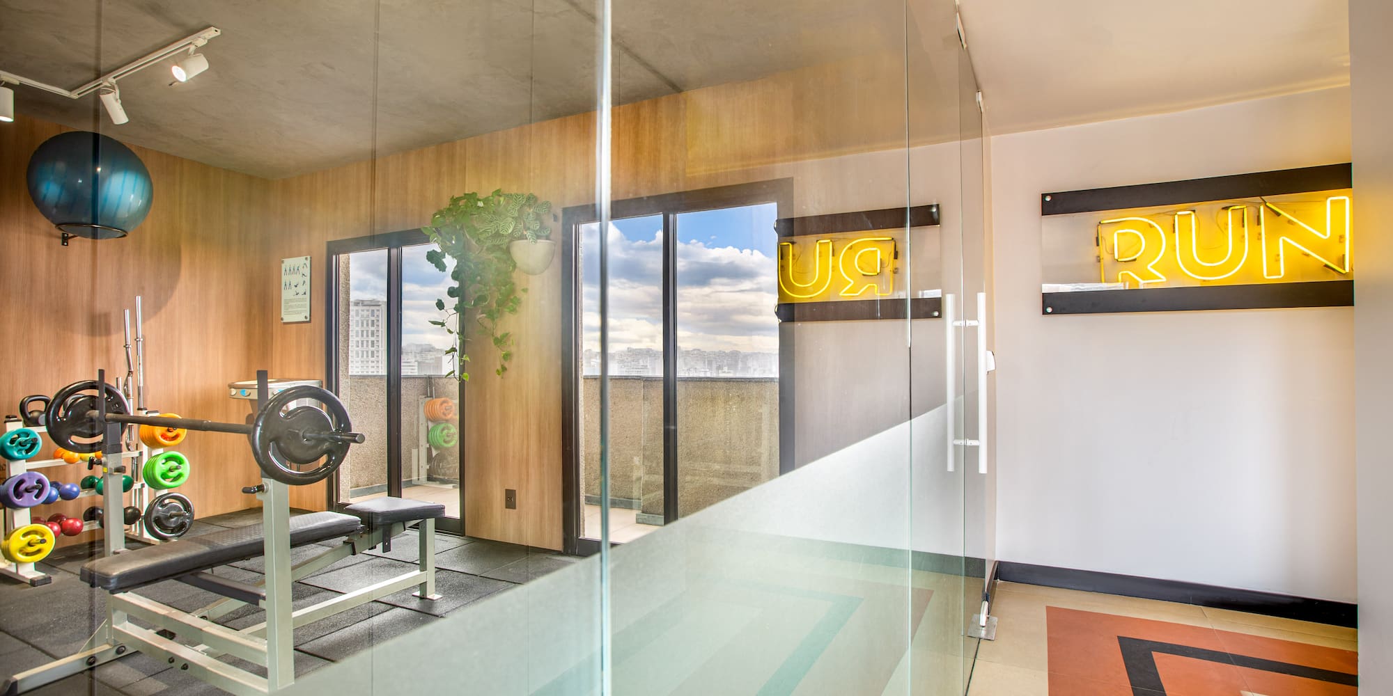 a room with a bench and a glass wall