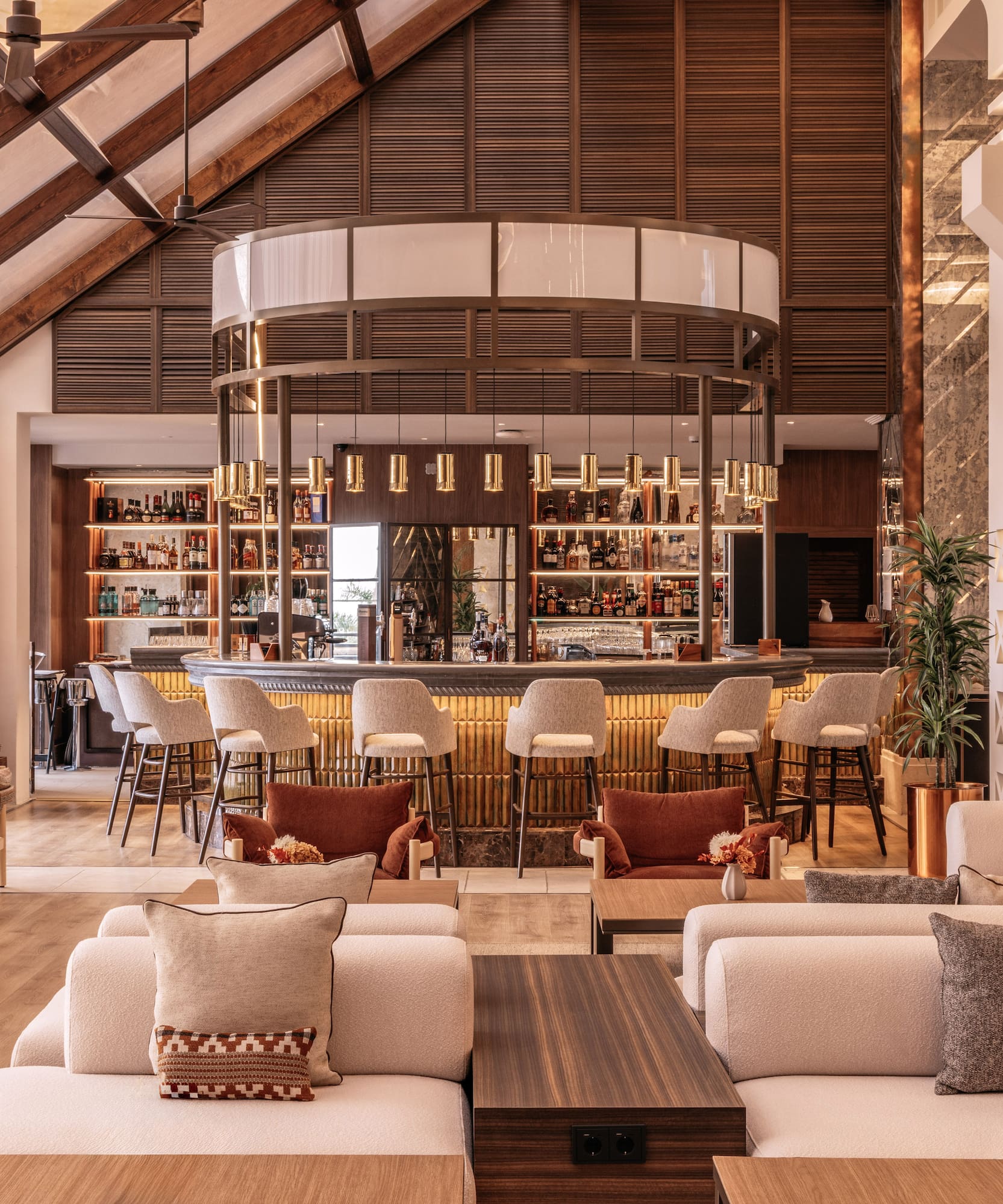 Modern hotel lounge bar, high vaulted ceilings, and stylish seating area.