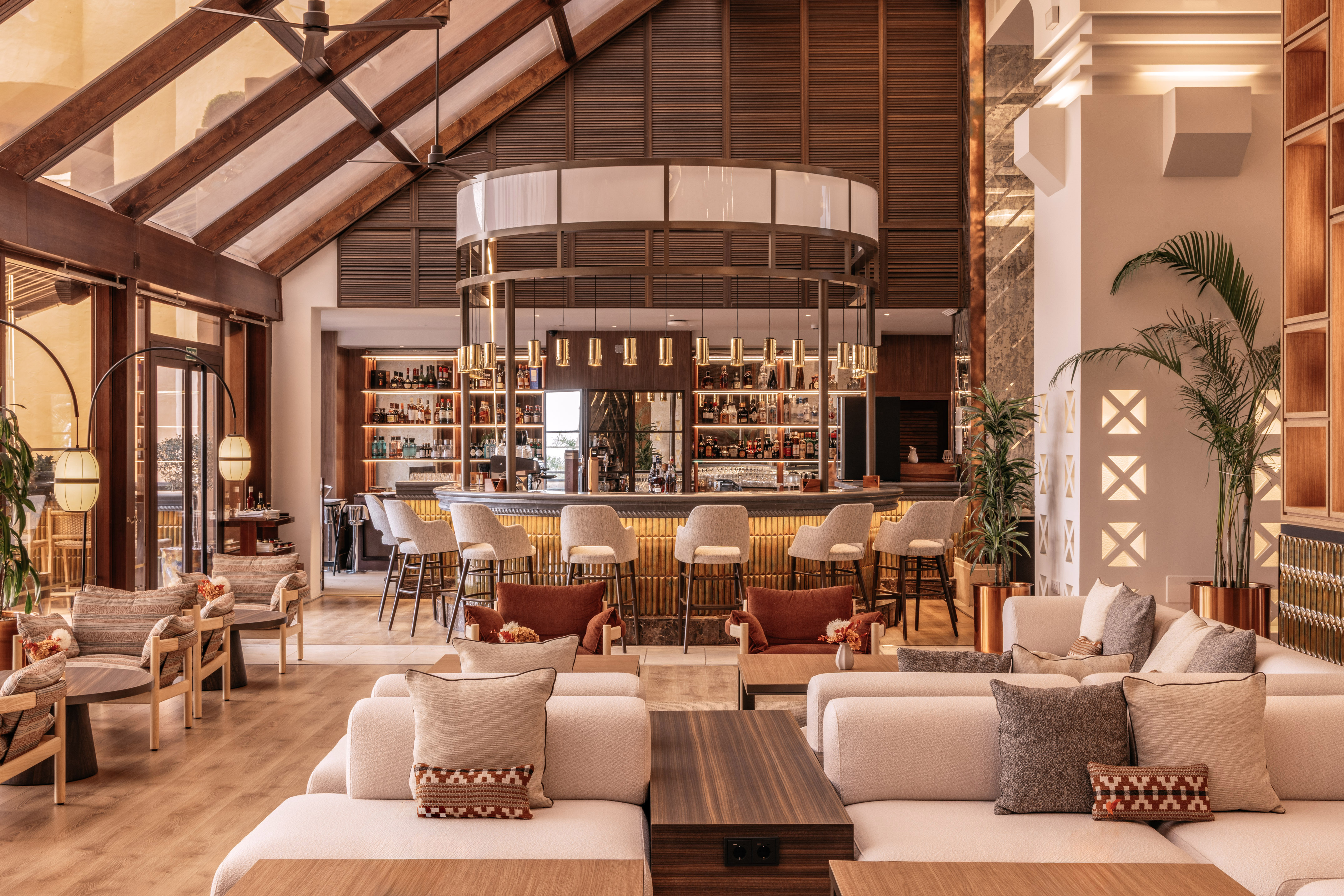 Modern hotel lounge bar, high vaulted ceilings, and stylish seating area.
