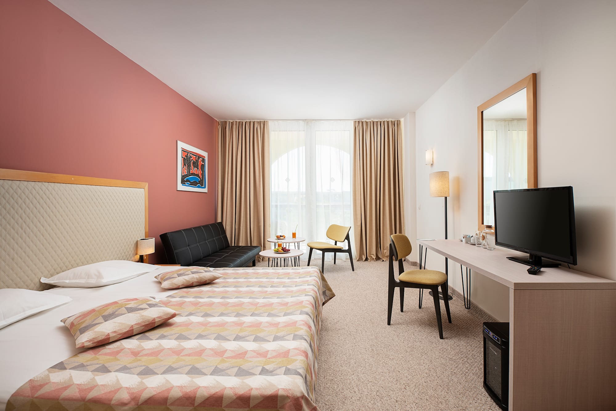 a room with a bed and a television