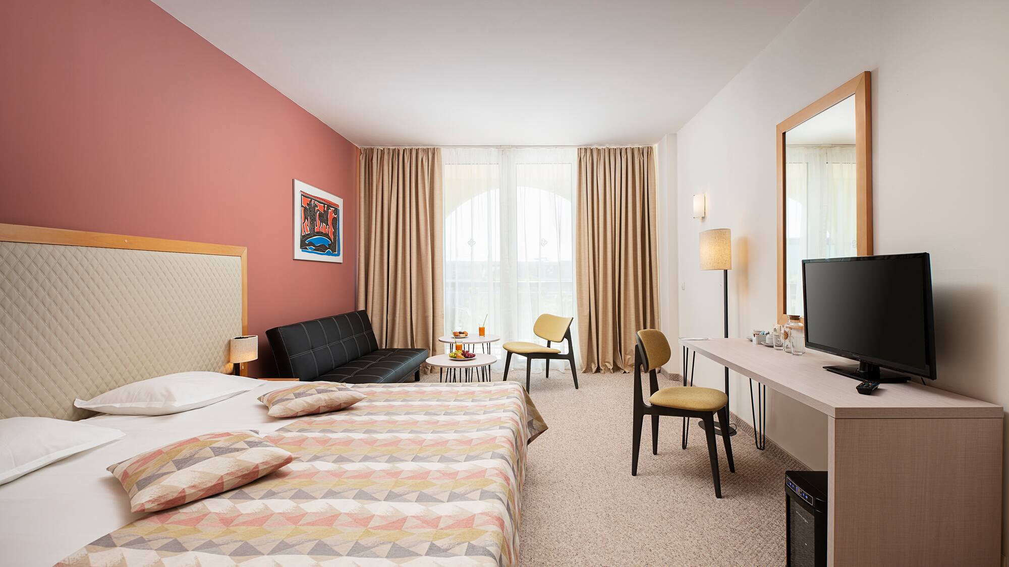 a room with a bed and a television