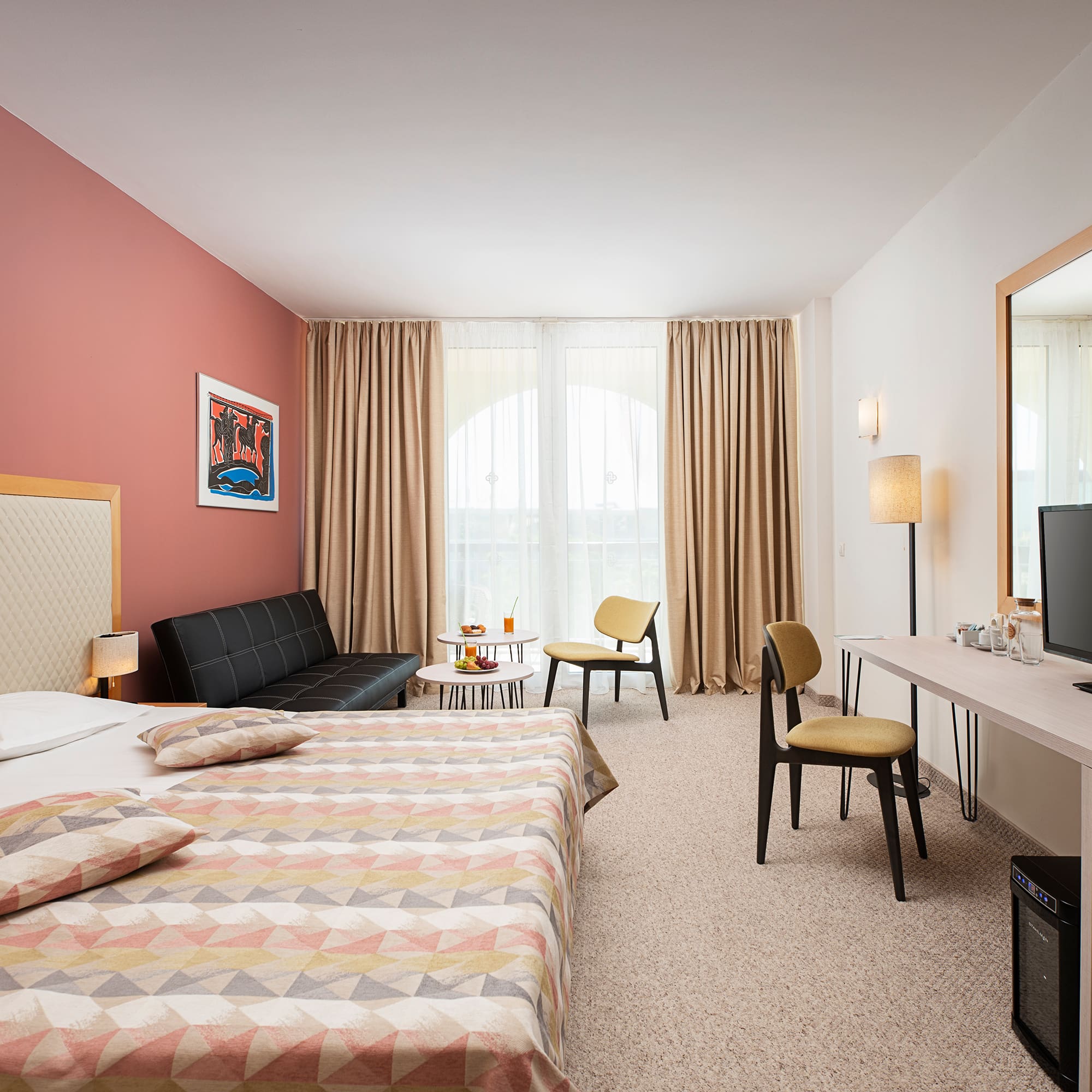 a room with a bed and a television