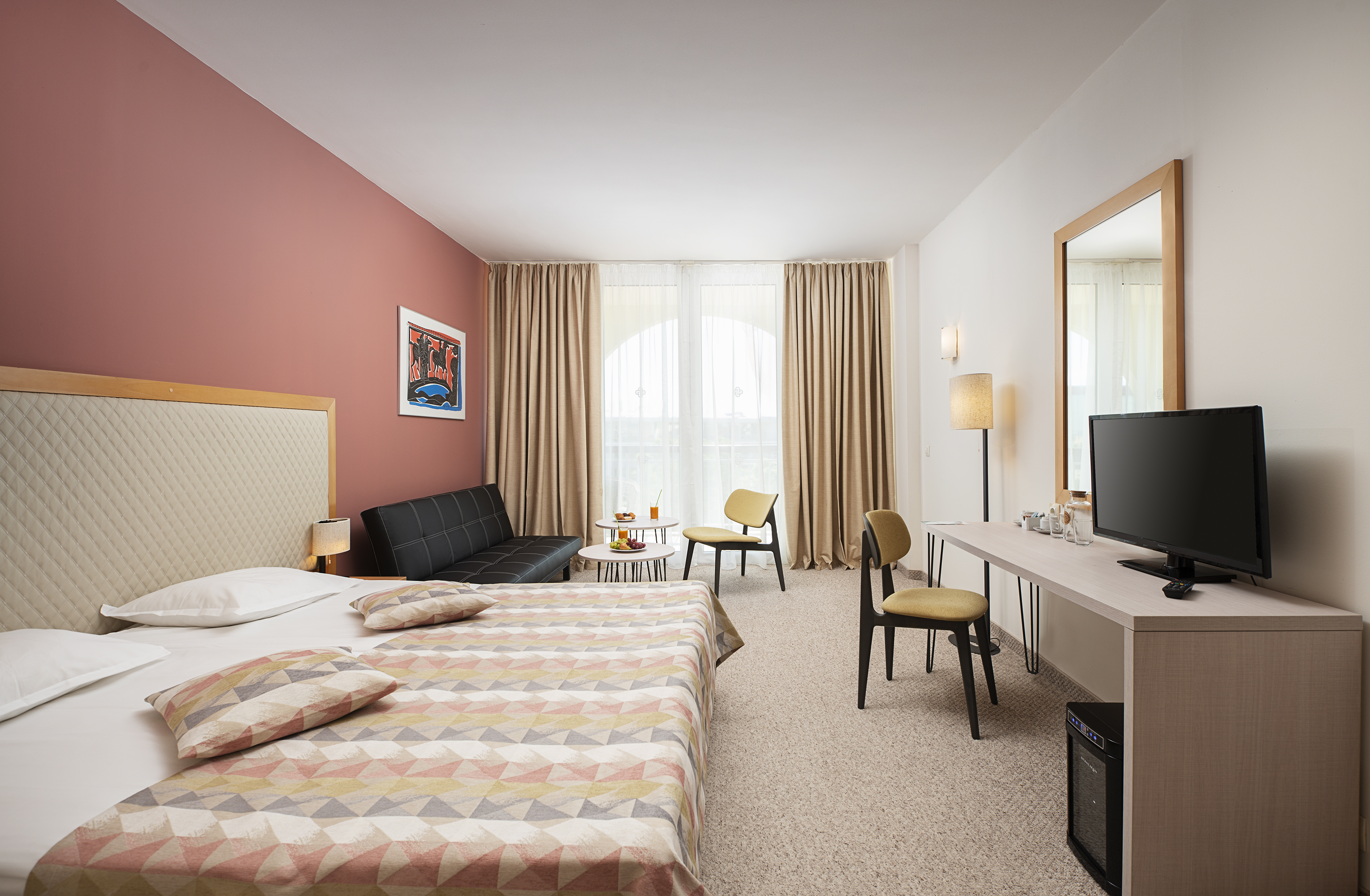 a room with a bed and a television