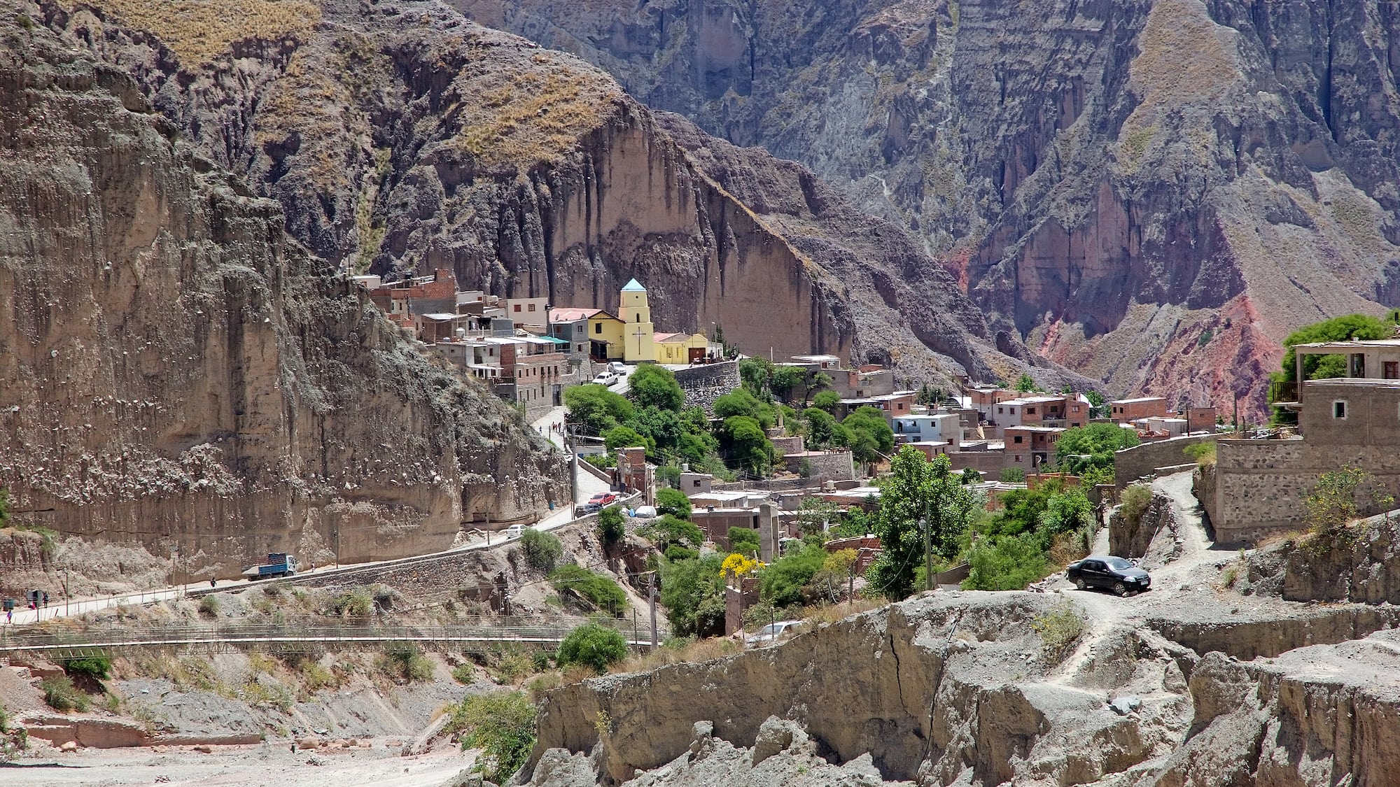 a car driving down a mountain