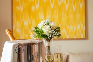 a champagne bucket and glasses of wine on a table