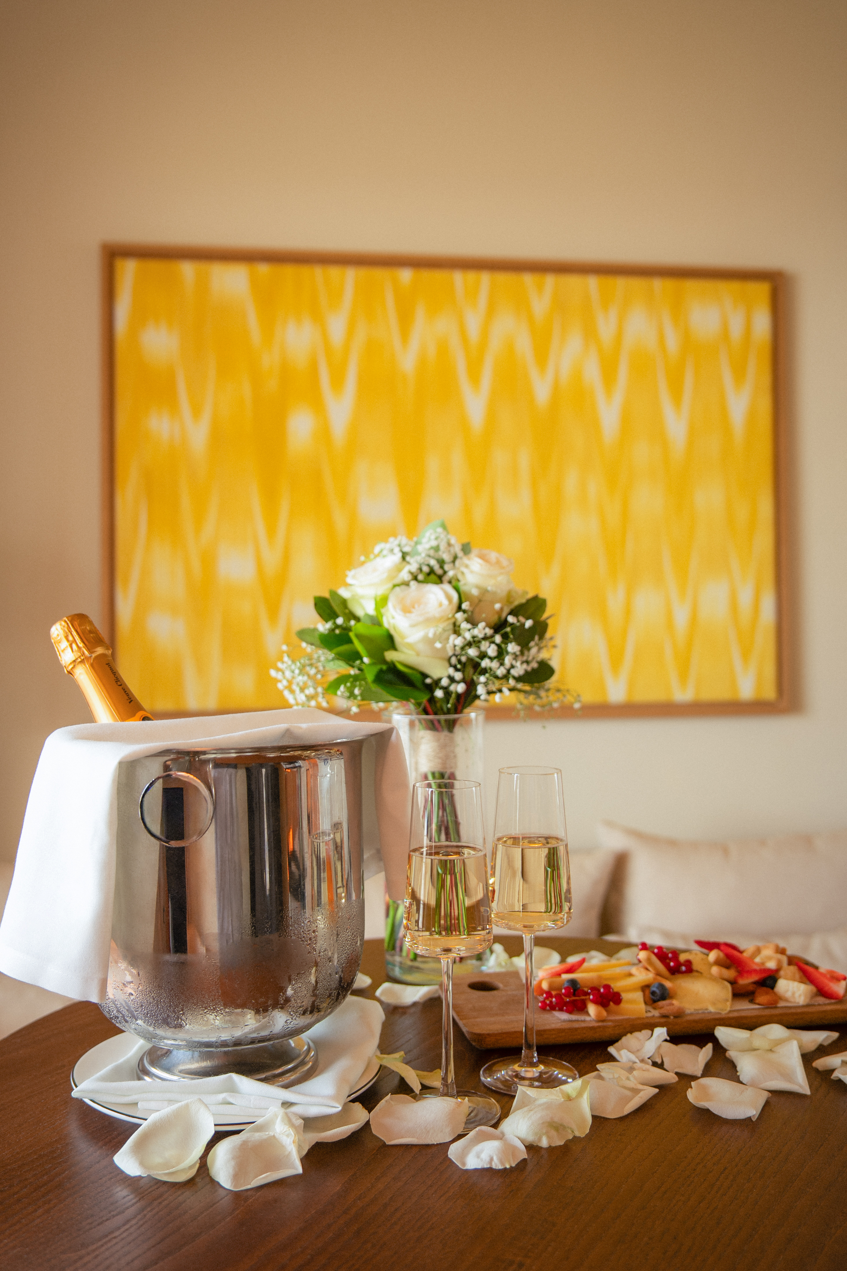 a champagne bucket and glasses of wine on a table