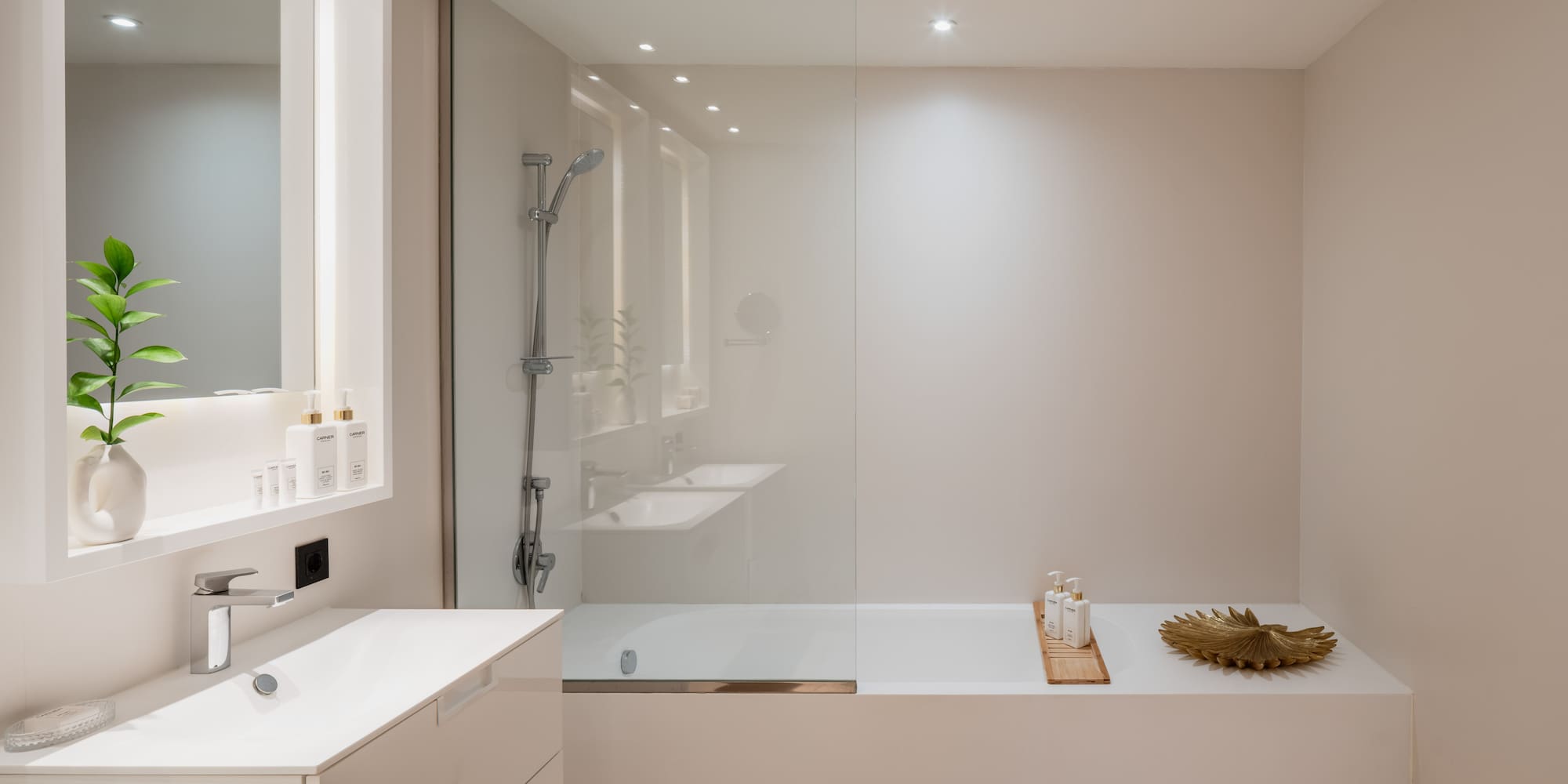 a bathroom with a glass shower and tub