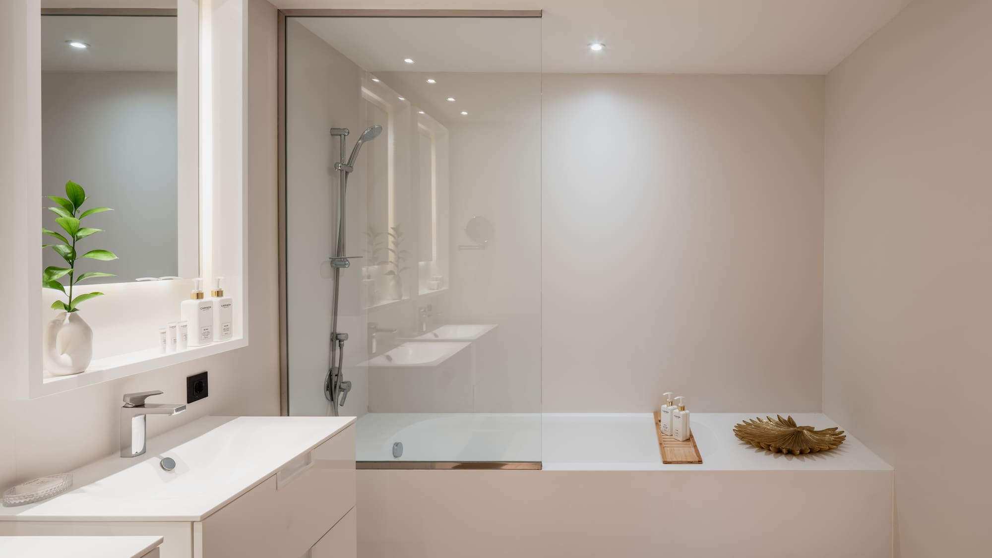 a bathroom with a glass shower and tub