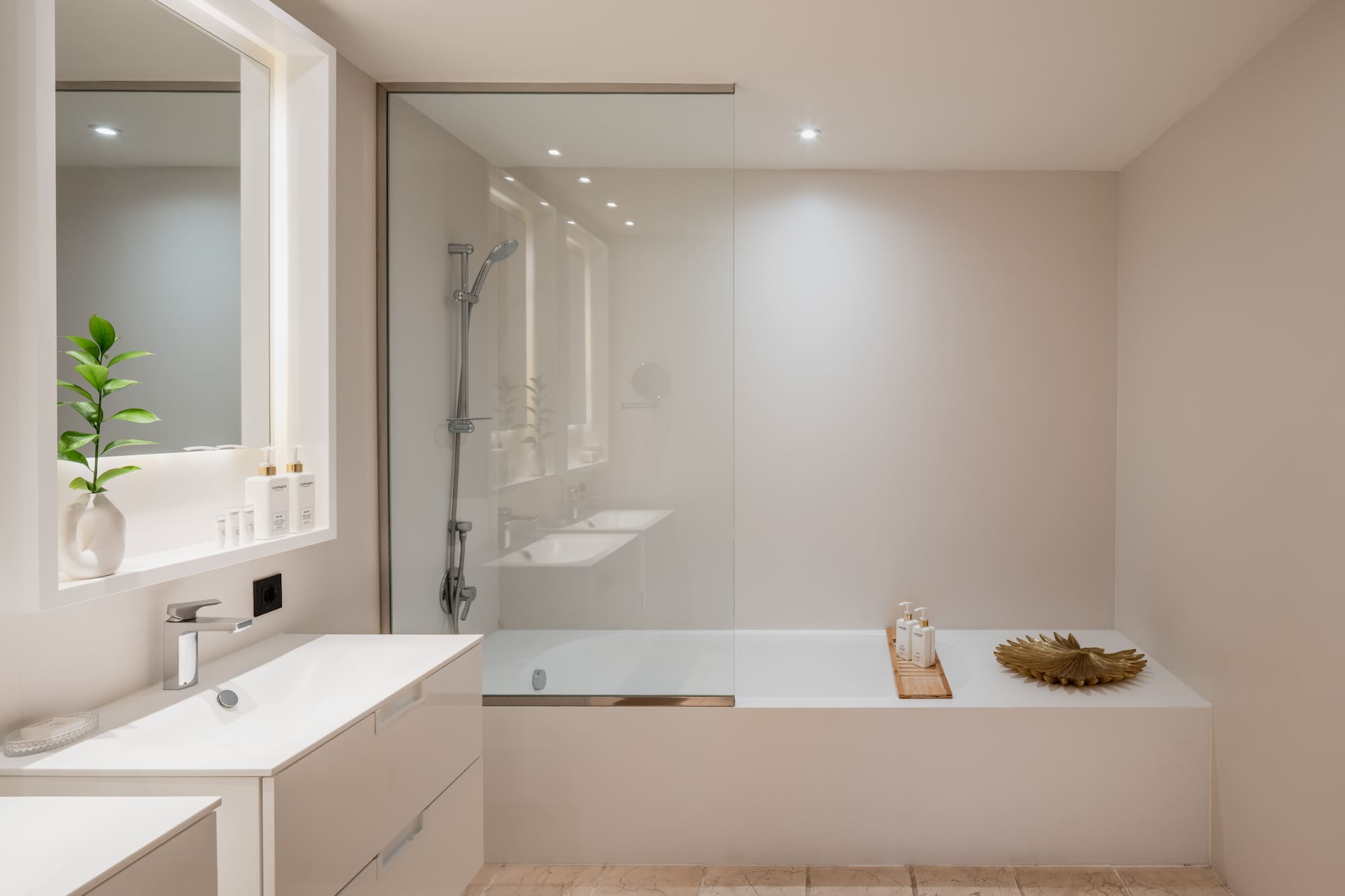 a bathroom with a glass shower and tub
