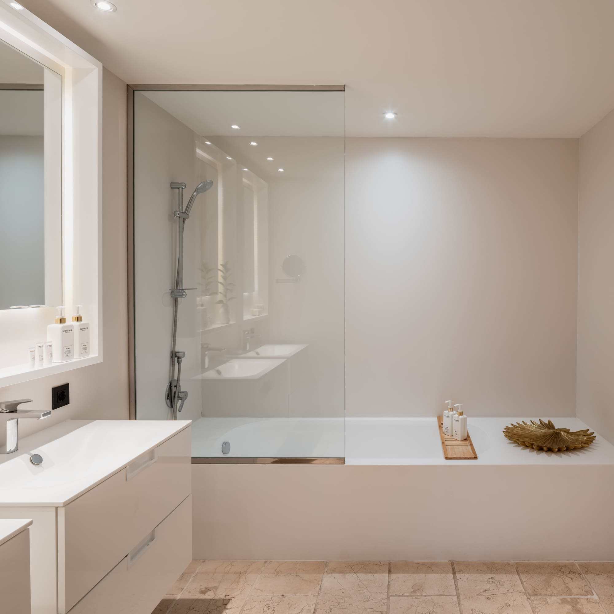 a bathroom with a glass shower and tub