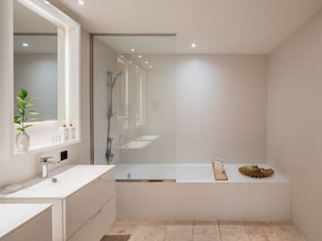 a bathroom with a glass shower and tub
