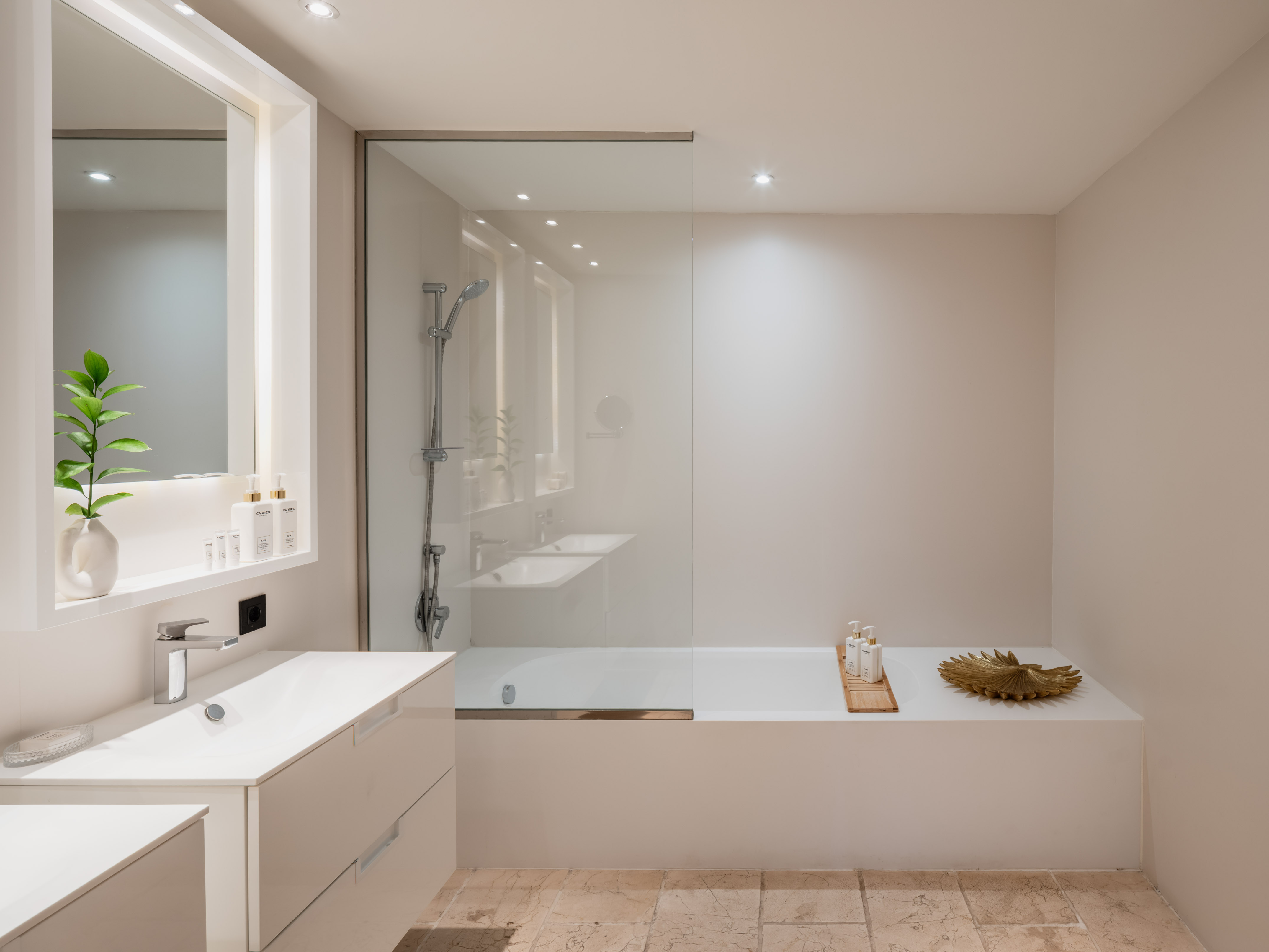 a bathroom with a glass shower and tub