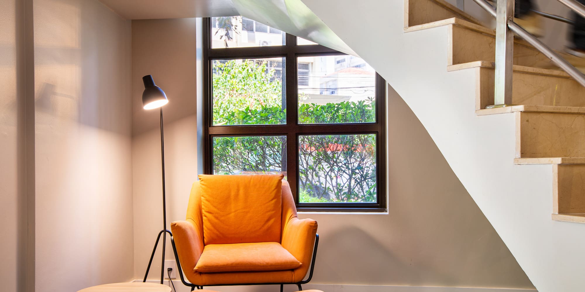 a chair and a table in a room with stairs
