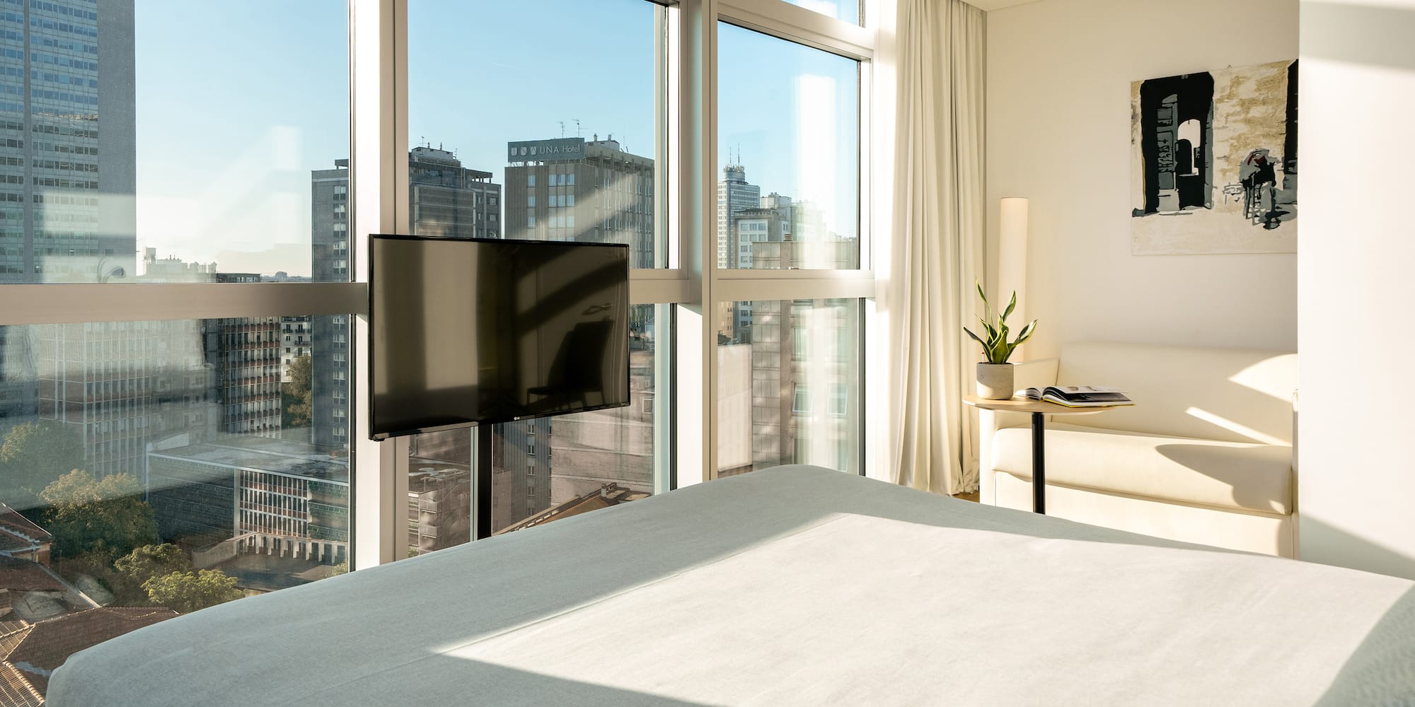 a bedroom with a television and a window