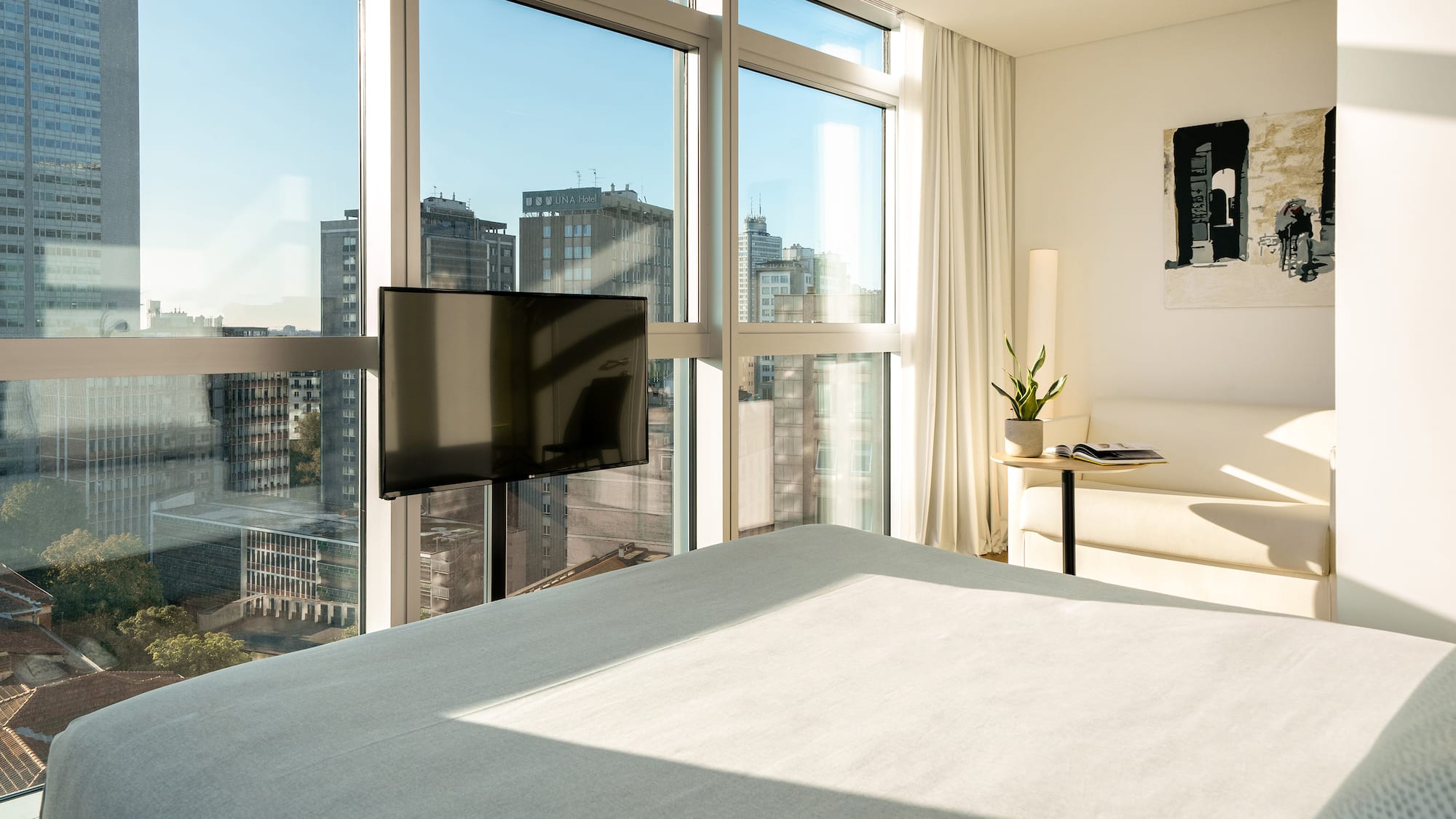 a bedroom with a television and a window