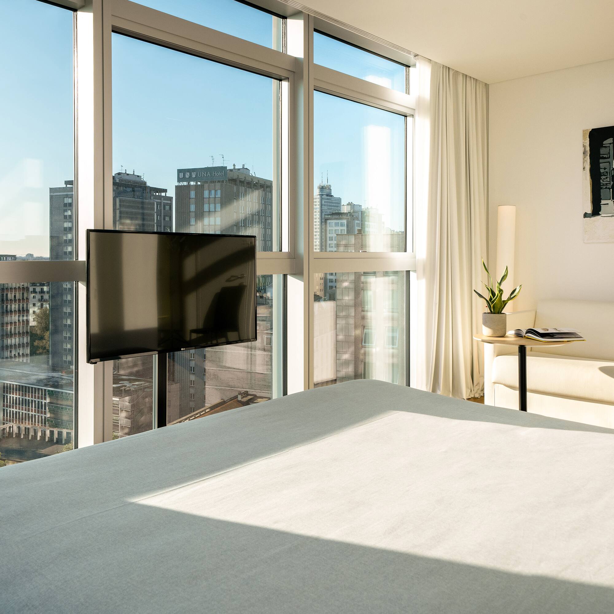 a bedroom with a television and a window