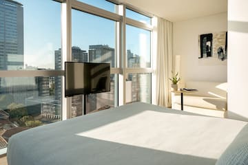 a bedroom with a television and a window