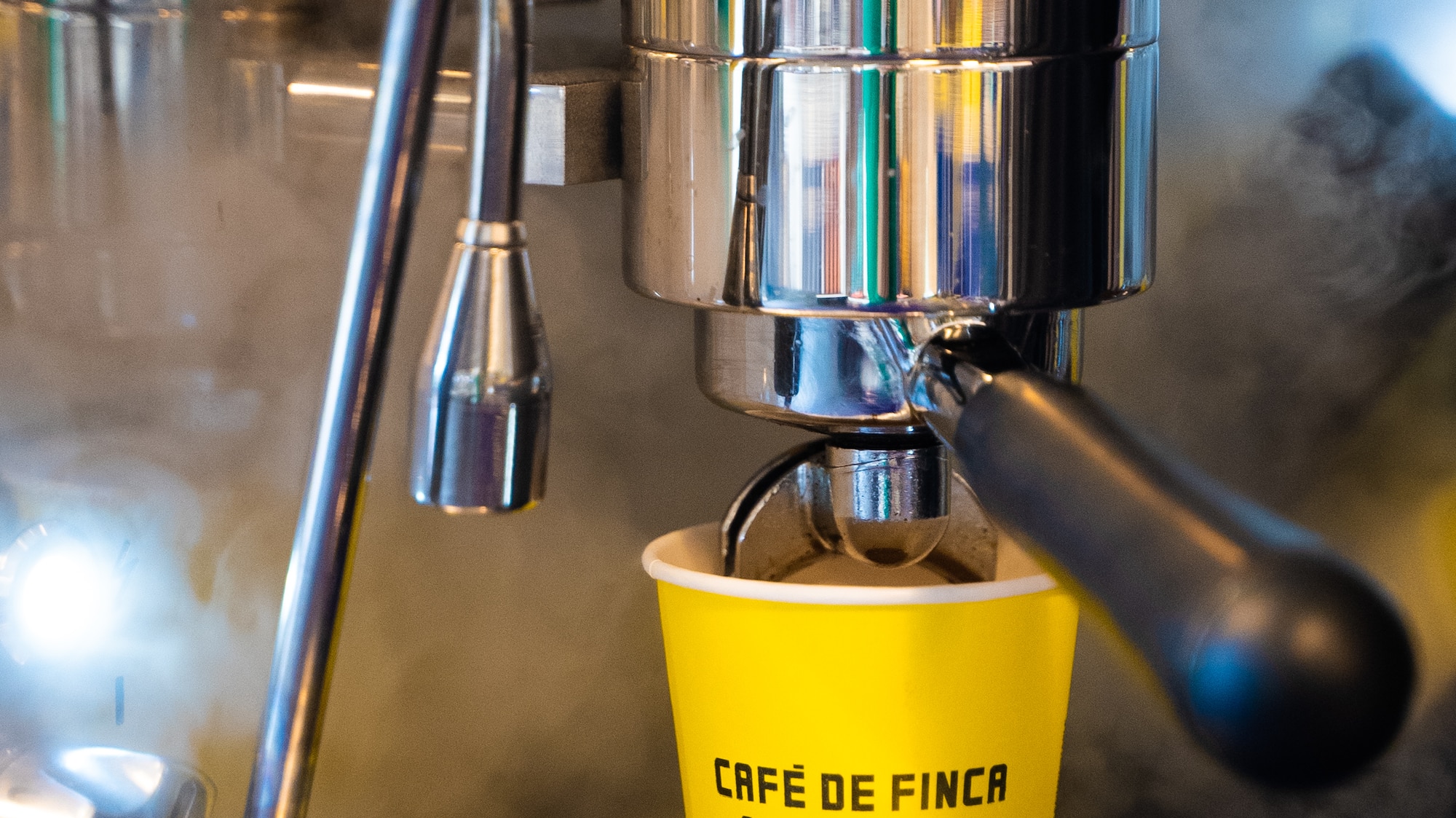 a coffee machine with a yellow cup