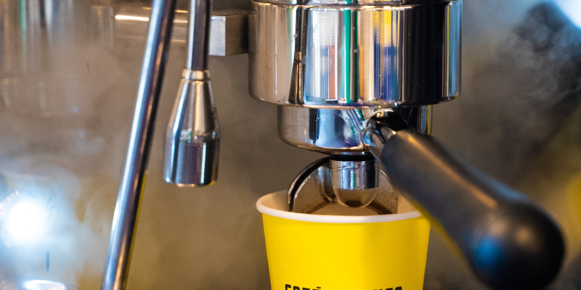 a coffee machine with a yellow cup