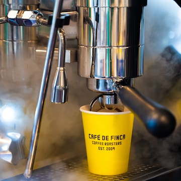 a coffee machine with a yellow cup