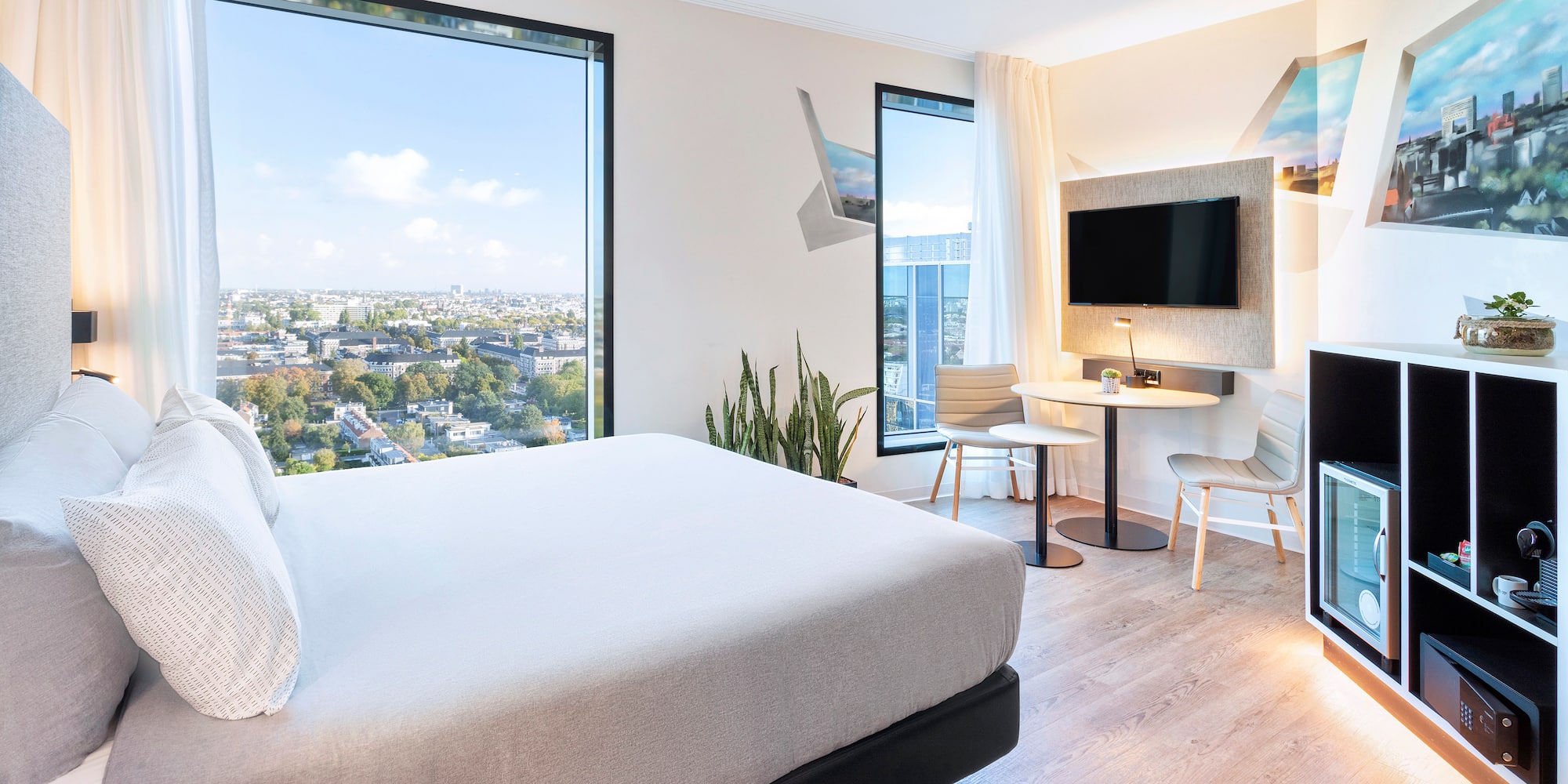 a room with a bed and a table and chairs