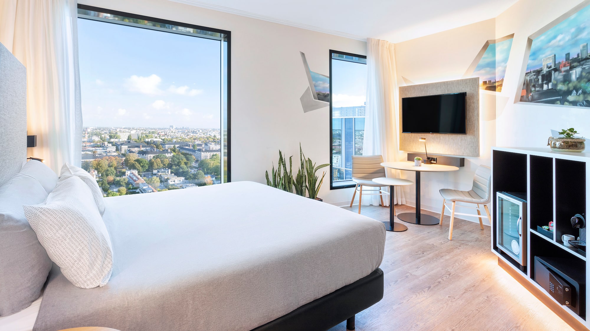 a room with a bed and a table and chairs