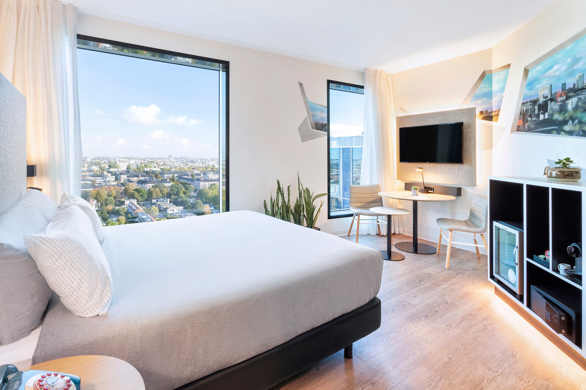 a room with a bed and a table and chairs