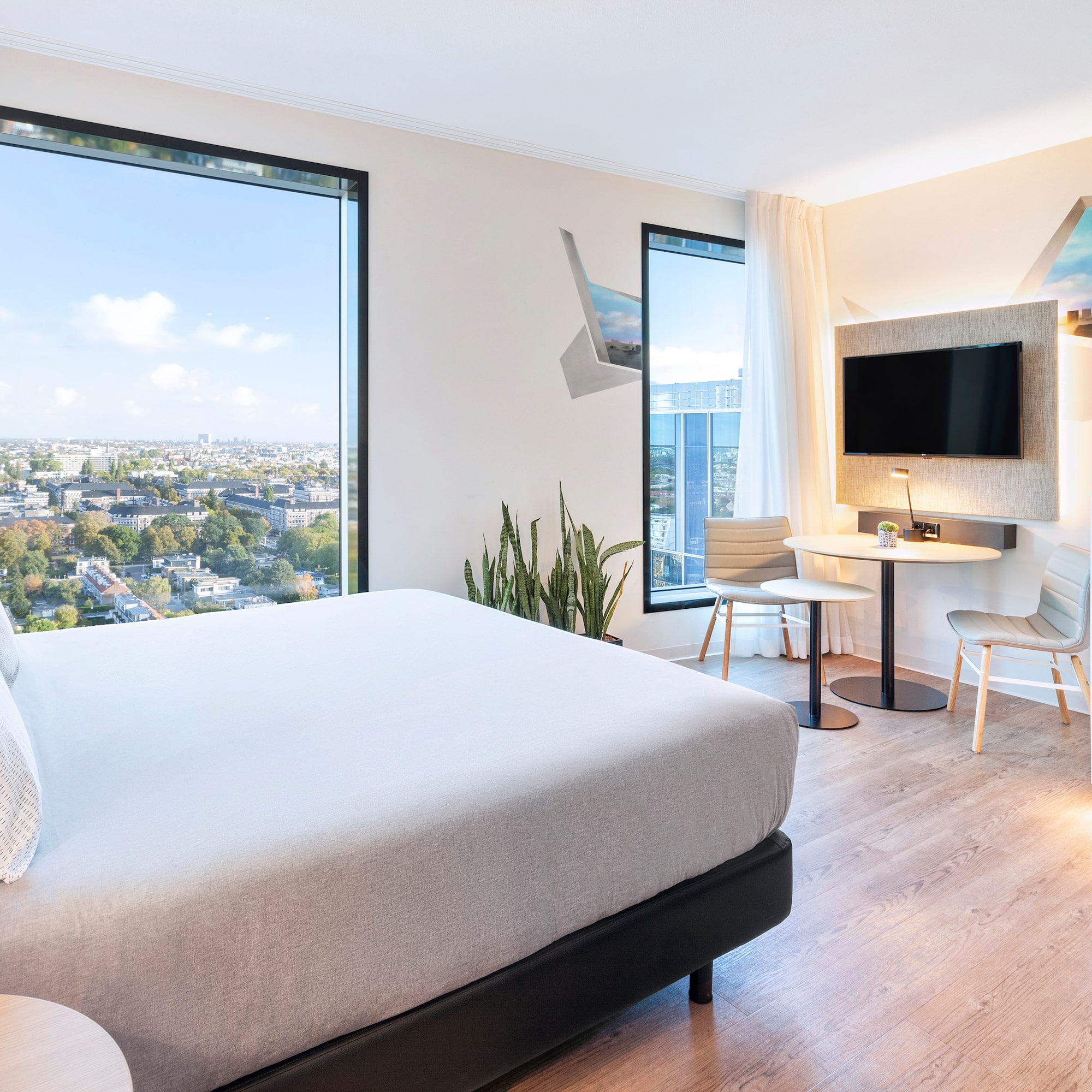 a room with a bed and a table and chairs