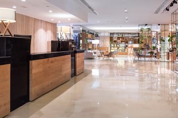 a lobby with a reception desk and chairs