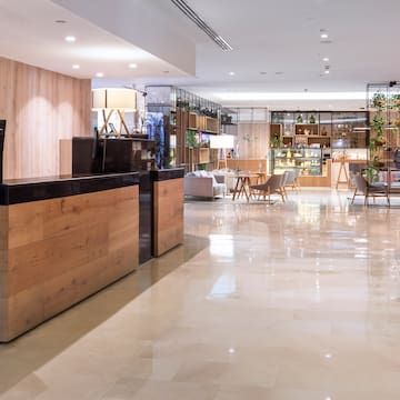 a lobby with a reception desk and chairs