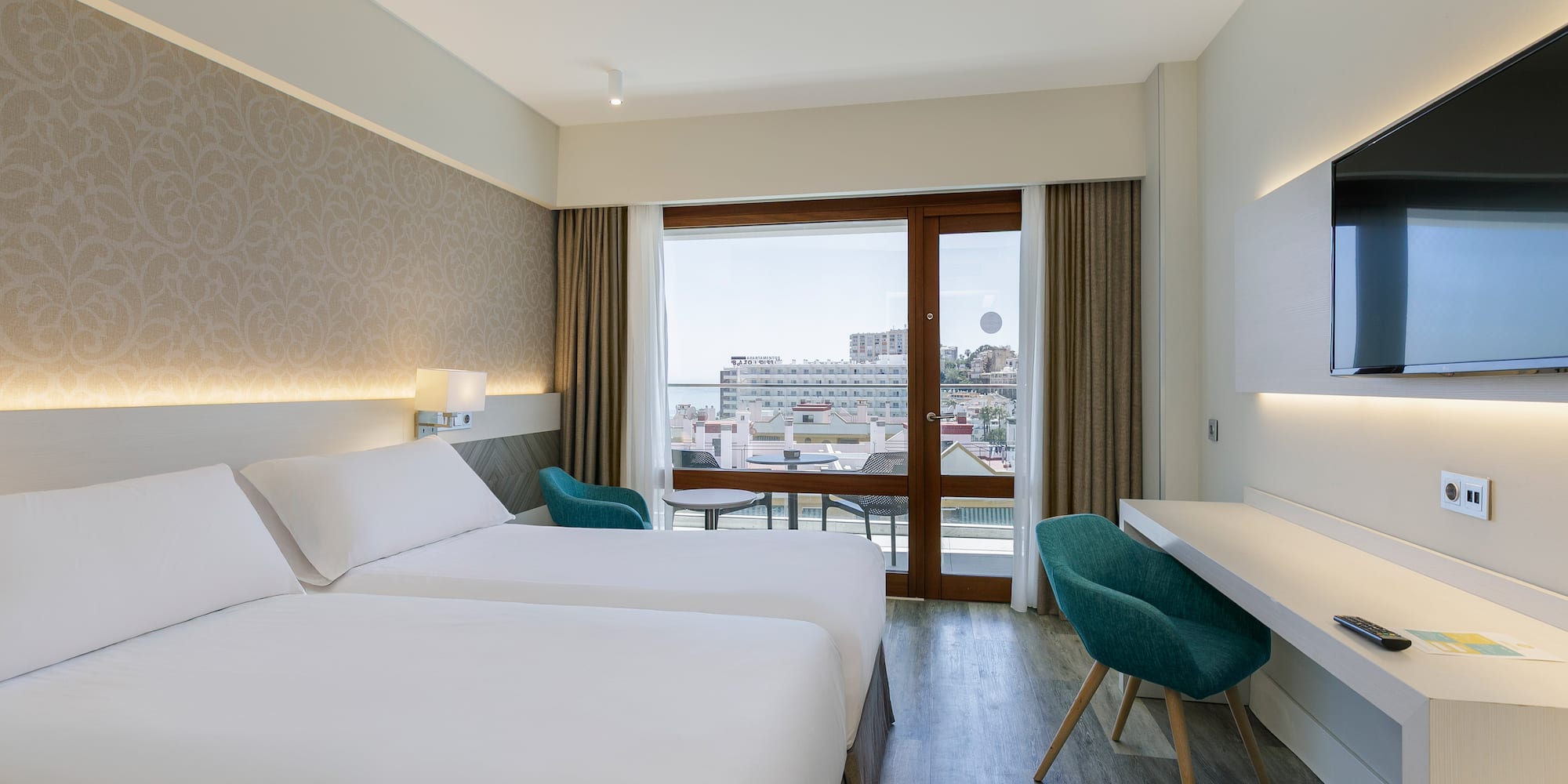 a room with two beds and a desk