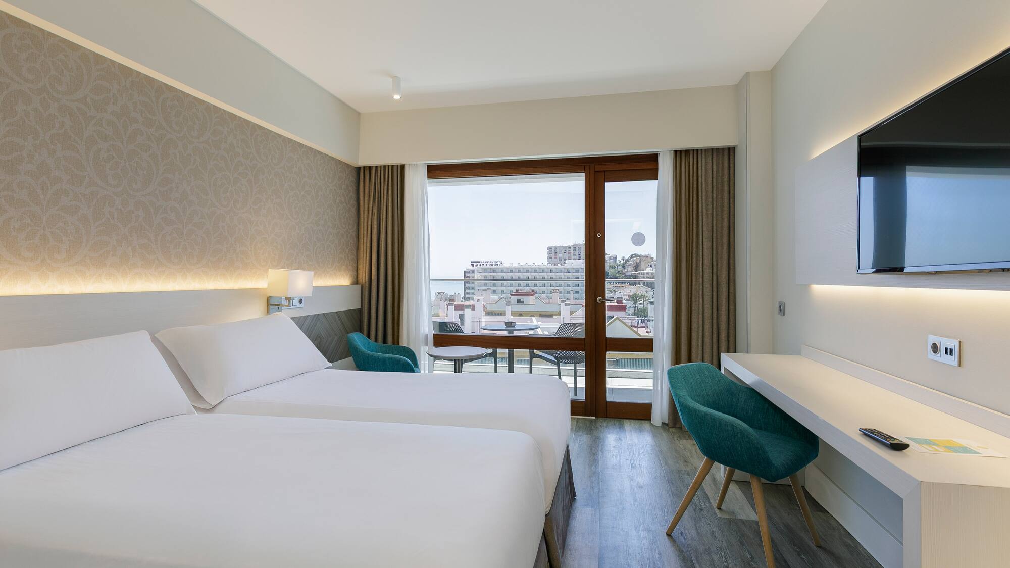 a room with two beds and a desk