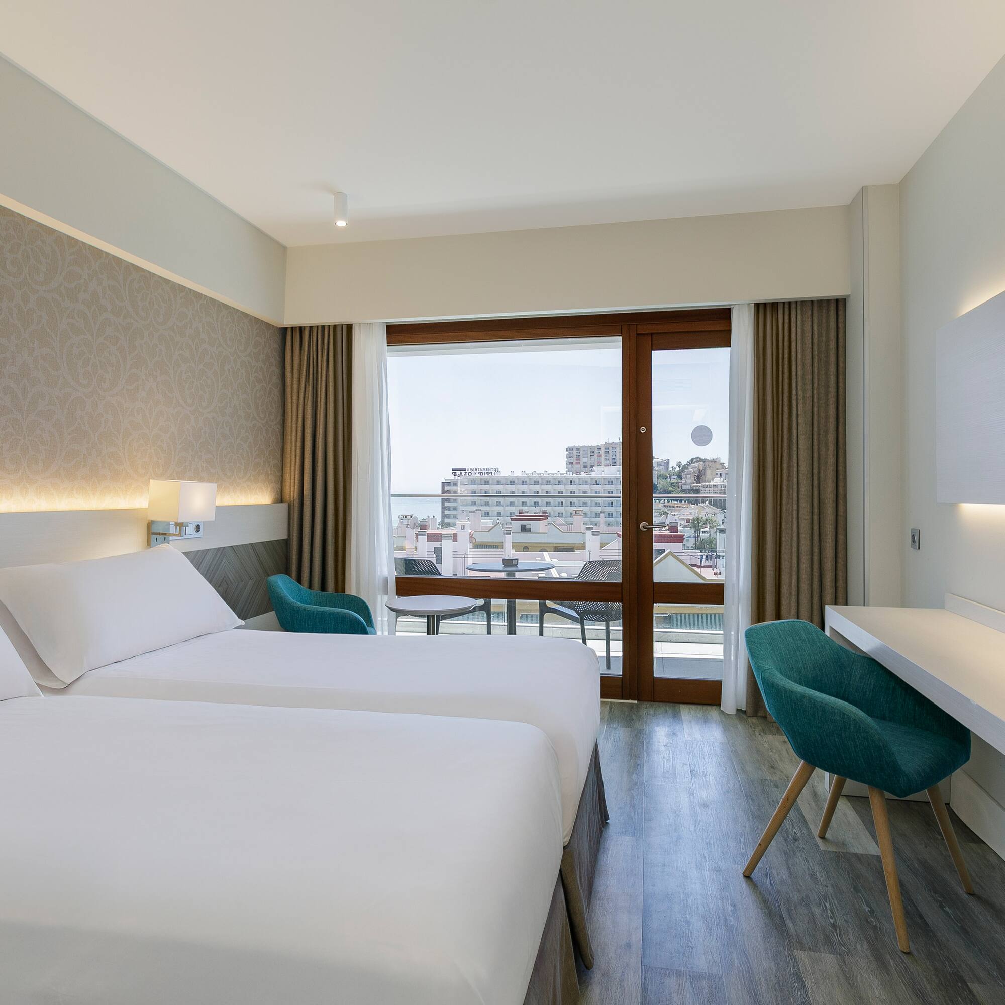 a room with two beds and a desk