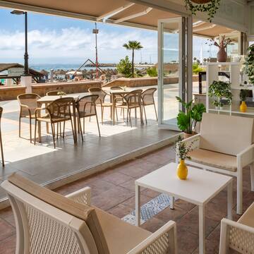 a patio with chairs and tables