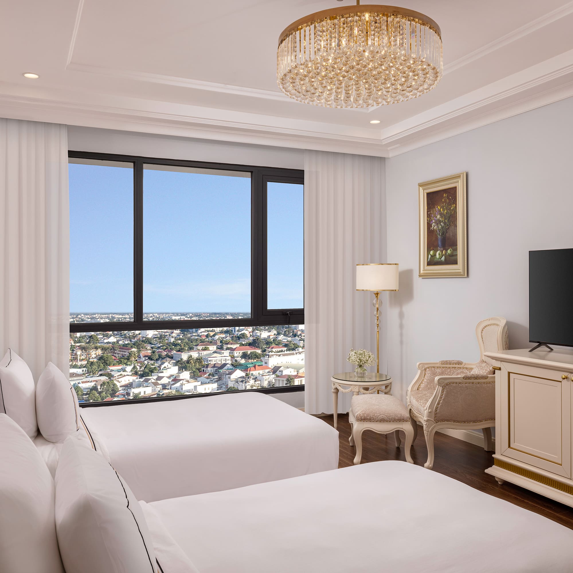 a room with two beds and a television