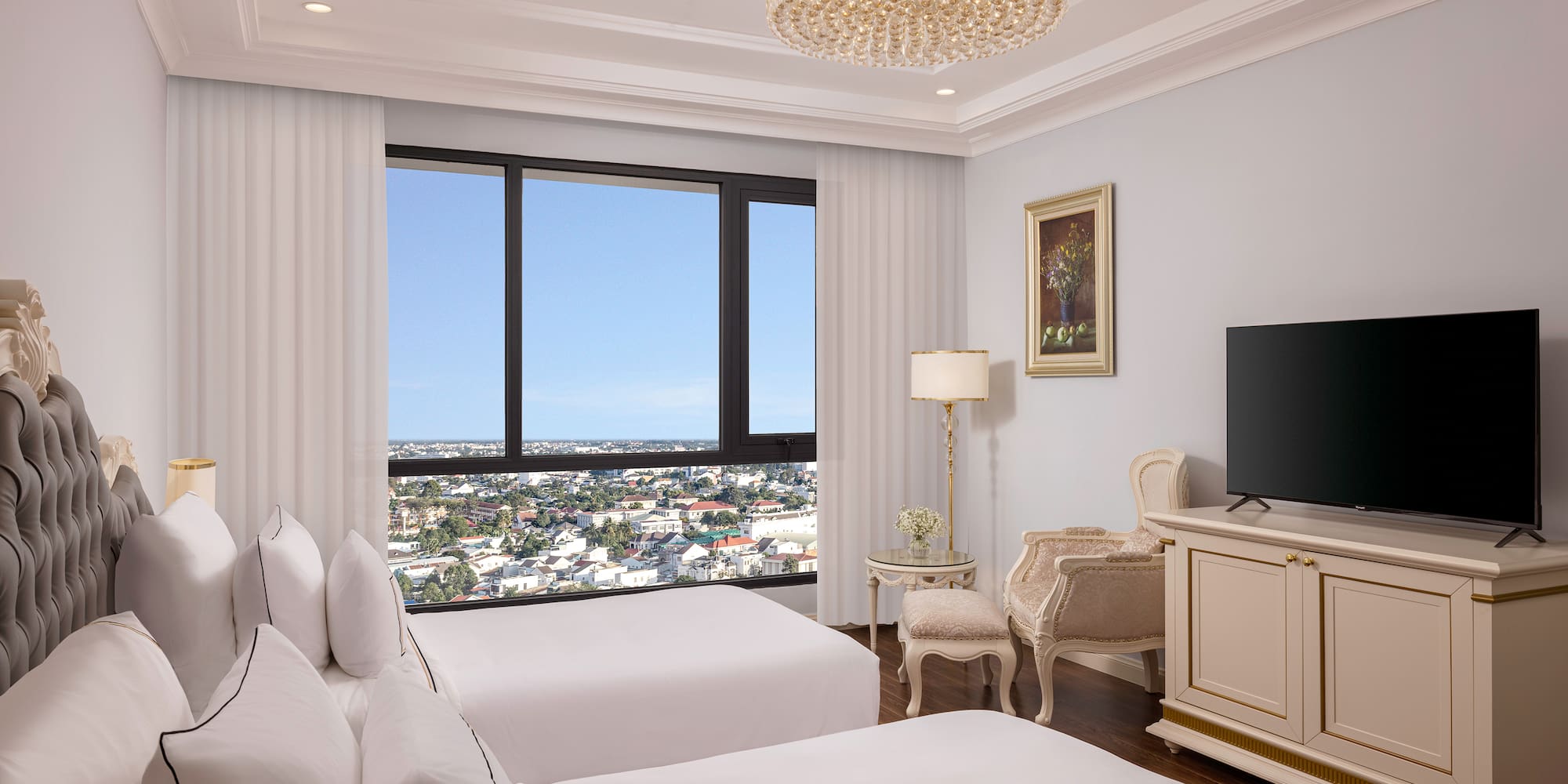 a room with two beds and a television