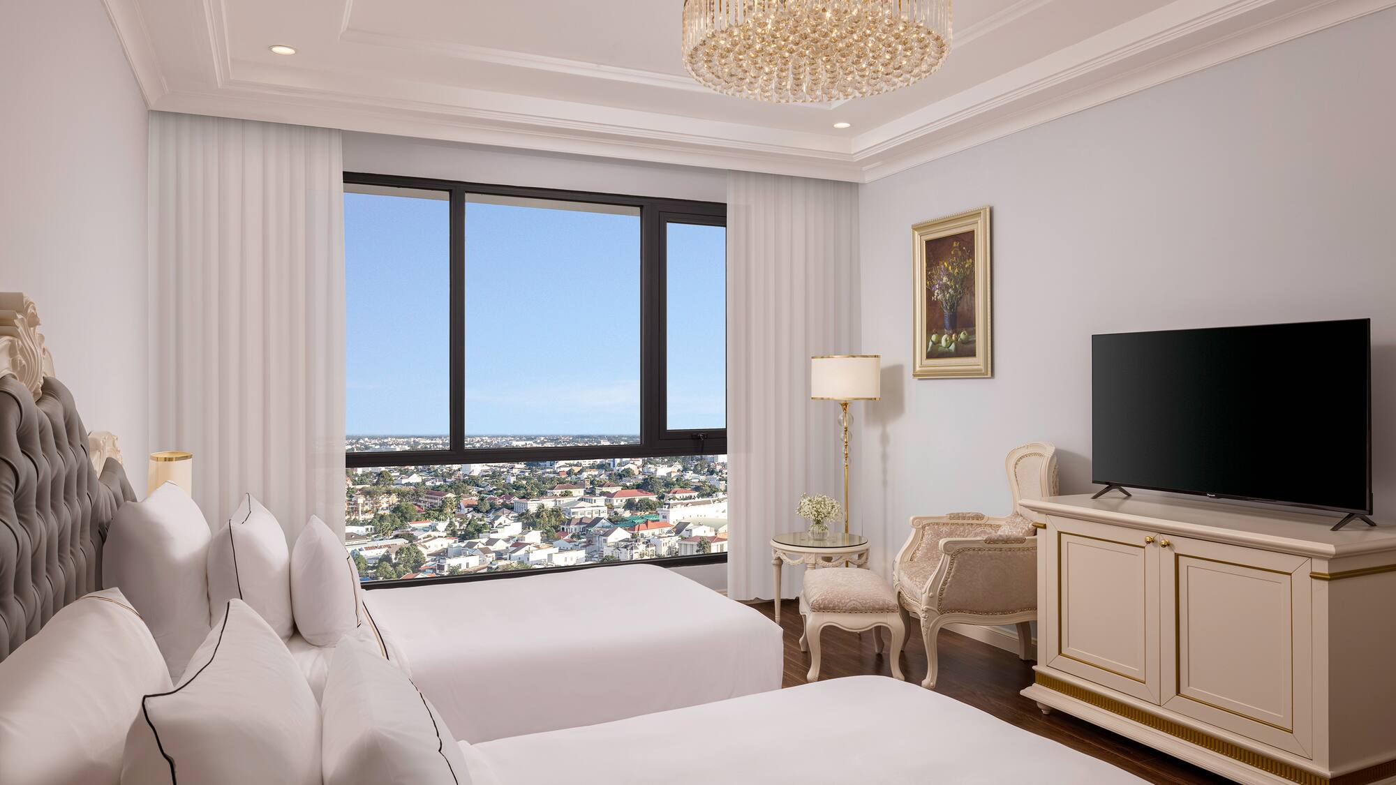 a room with two beds and a television