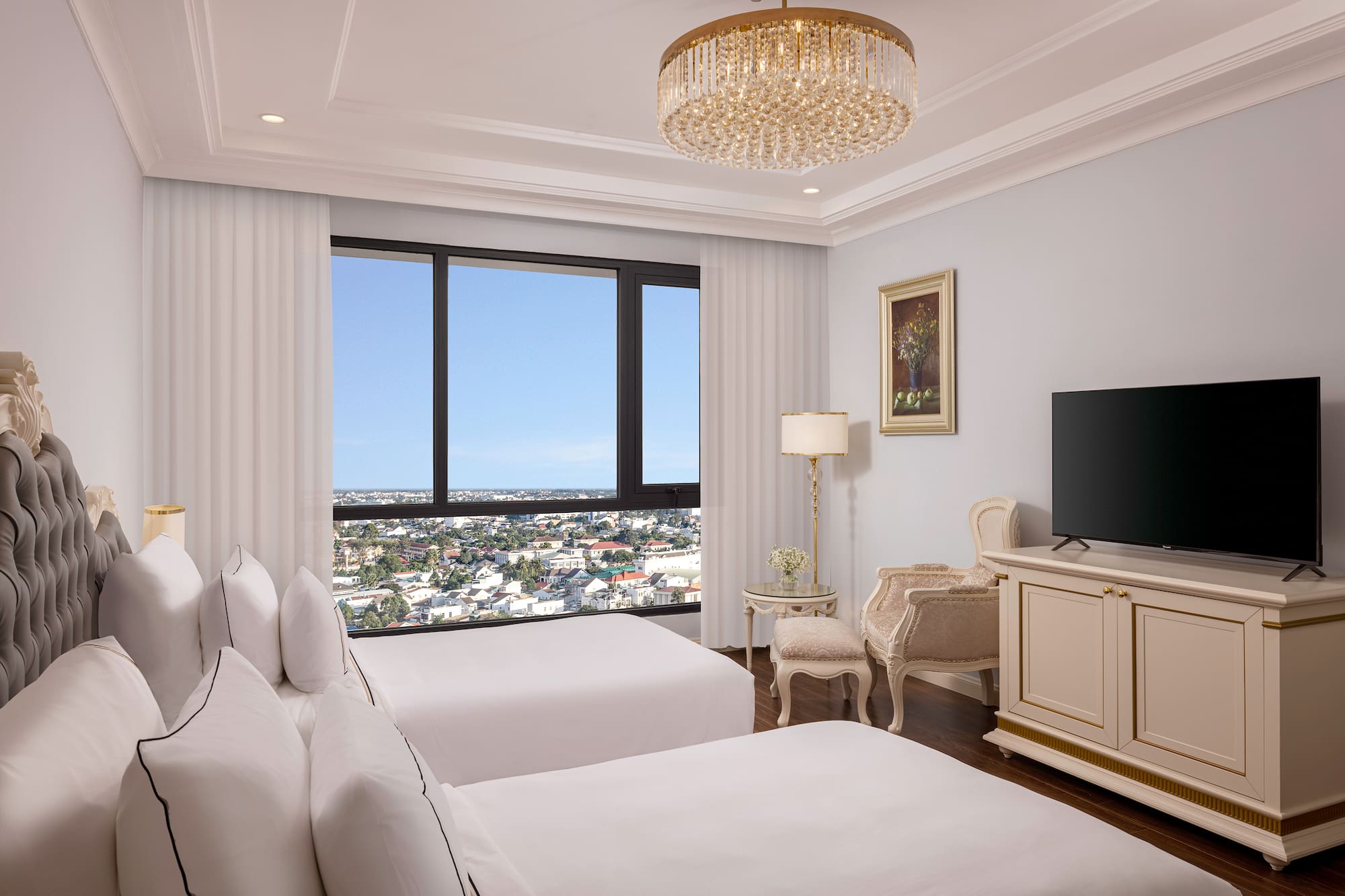 a room with two beds and a television