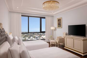 a room with two beds and a television