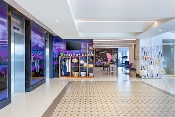 a room with a purple wall and a mirror