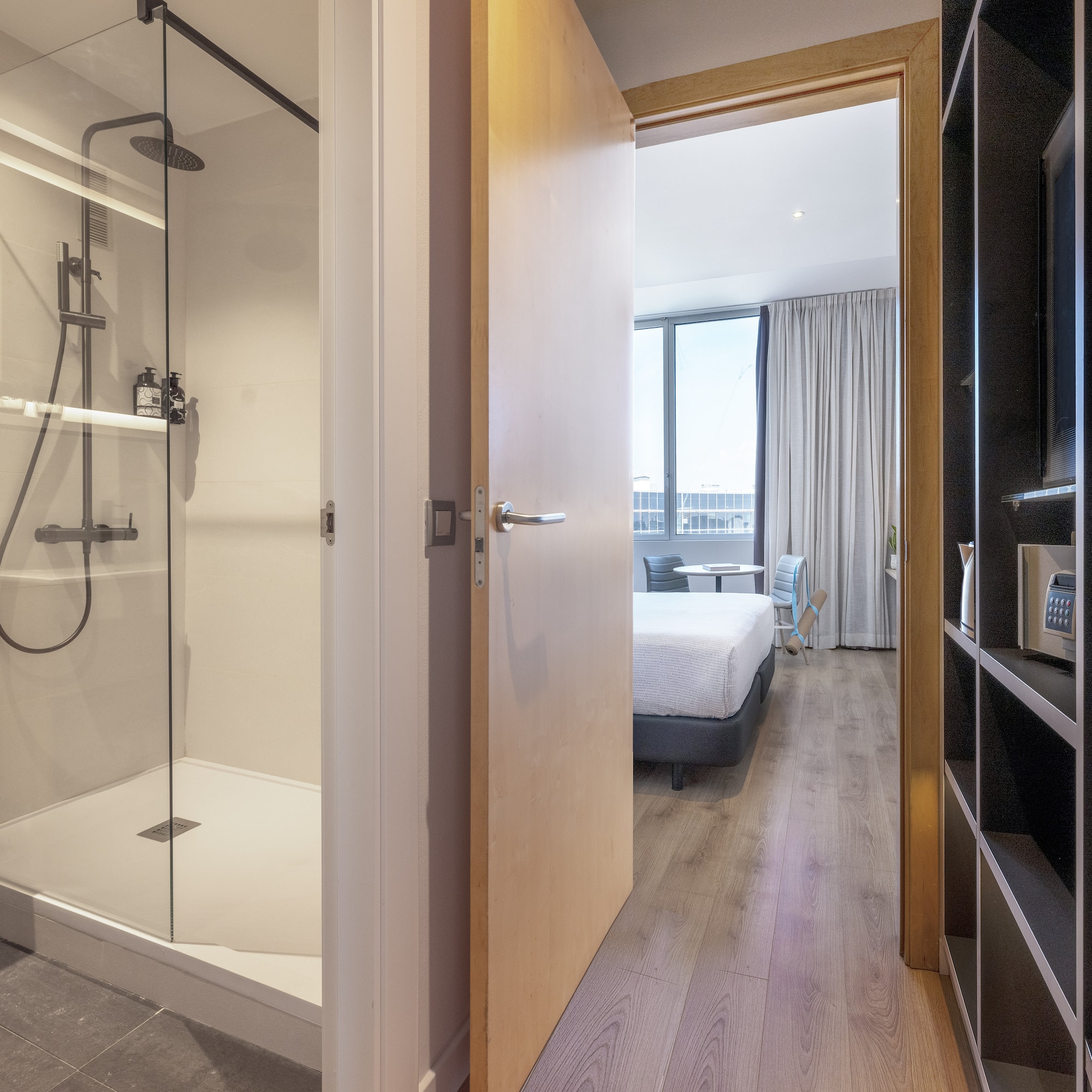 a bathroom with a shower and a bed