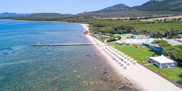 a beach with a dock and a body of water