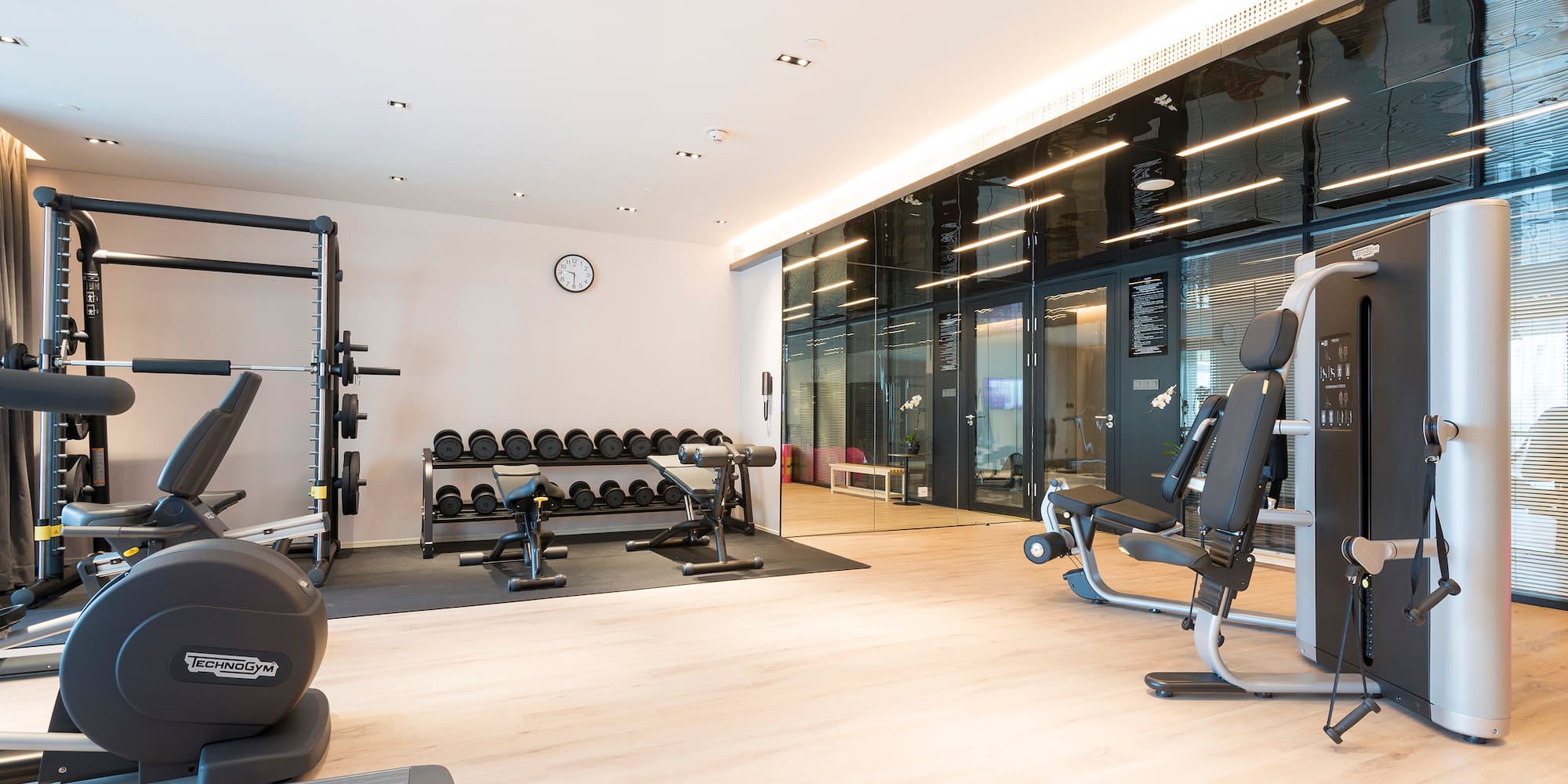 a room with exercise equipment and a large wall
